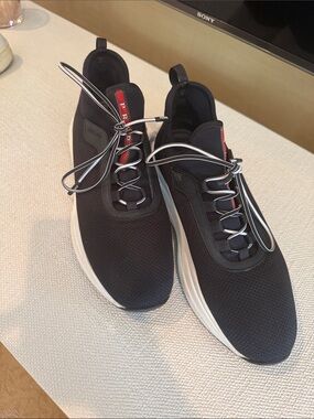 Prada Black Sneakers with White Sole and Red Tongue Detail